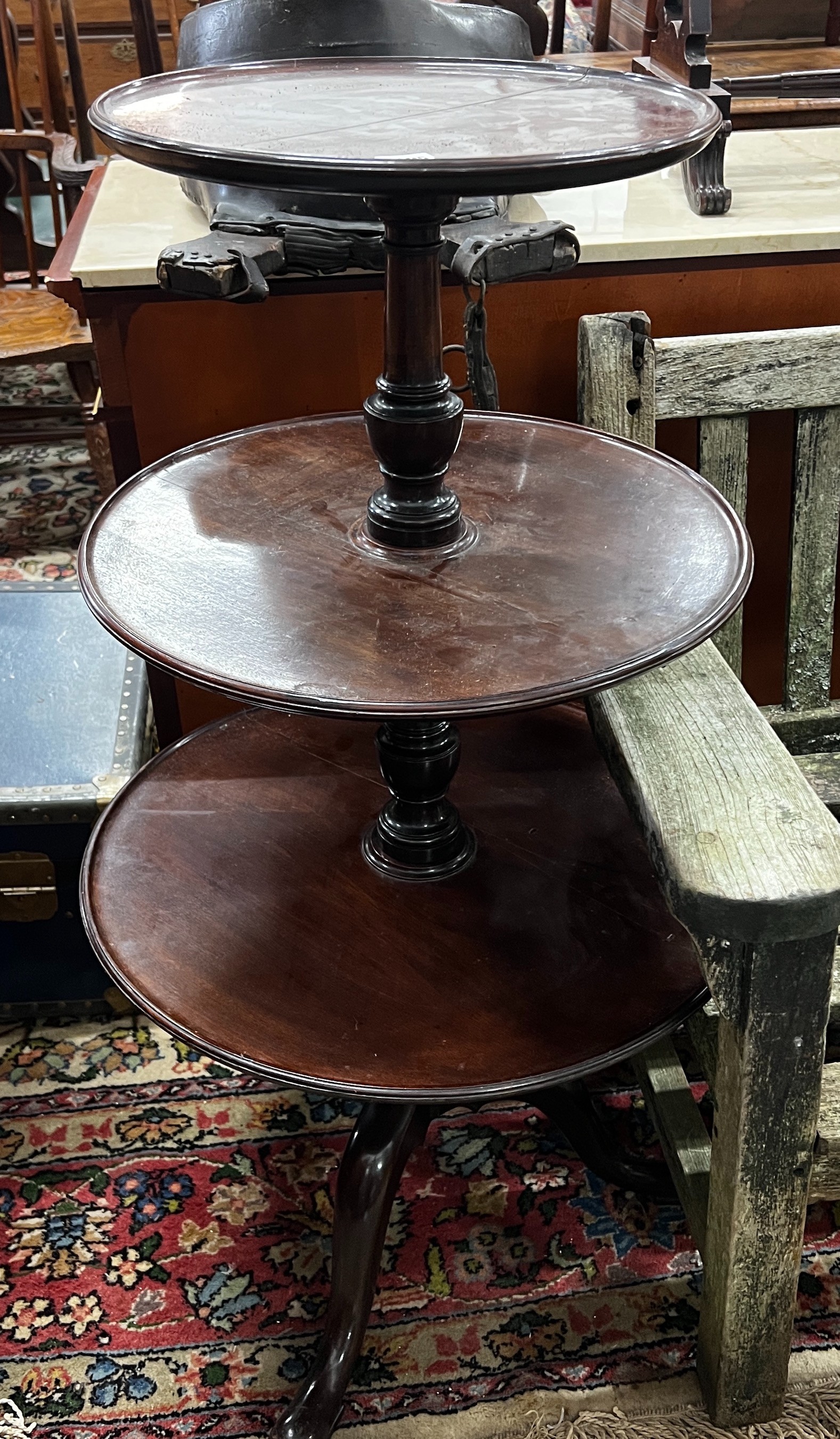 A George III and later circular mahogany three tier dumb waiter, height 108cm